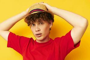 guy with red curly hair casual wear hat posing yellow background unaltered photo