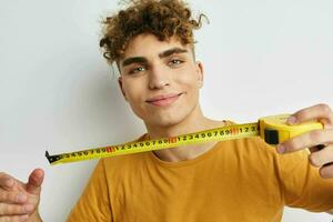 handsome guy grimace measuring tape posing Lifestyle unaltered photo