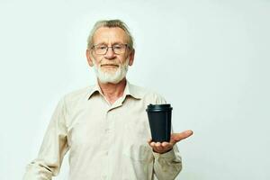 Portrait elderly man in a shirt and glasses a black glass isolated background photo