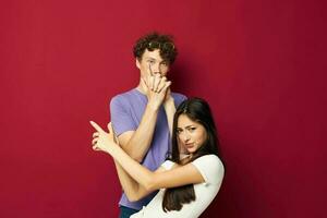 guy and girl posing studio red background photo