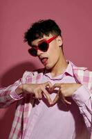 portrait of a young man plaid blazer fashion modern style glasses pink background unaltered photo