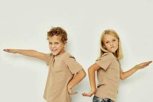 Boy and girl gesticulate with their hands together childhood unaltered photo