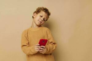 smiling boy in a sweater with a phone in his hands communication photo