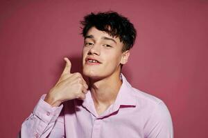 Photo of romantic young boyfriend in a pink shirt gesturing with his hands Lifestyle unaltered