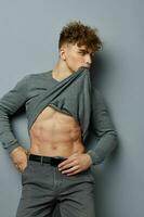 Attractive man posing inflated torso model Gray background photo