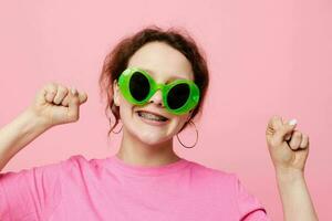 Stylish teenager girl model with green glasses decoration gesture with his hands photo