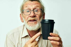 Senior grey-haired man in a shirt and glasses a black glass isolated background photo