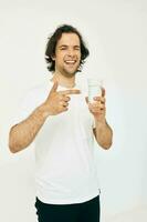handsome man glass of water in his hands emotions posing beige background photo