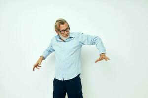 Portrait elderly man in blue shirts gestures with his hands isolated background photo