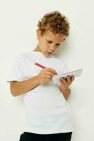 Boy draws with pencil in notebook entertainment studio photo