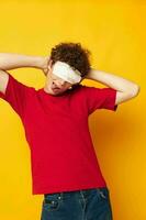 guy with red curly hair wearing a red t-shirt medical mask on the face posing Lifestyle unaltered photo