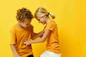 picture of positive boy and girl cuddling fashion childhood entertainment on colored background unaltered photo