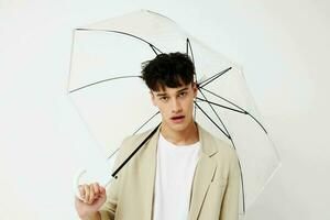 handsome guy transparent umbrella a man in a light jacket isolated background unaltered photo