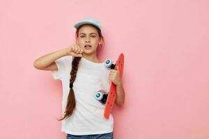 retrato de contento sonriente niño niña gorra en blanco camiseta patineta aislado antecedentes foto