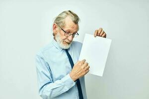 Portrait elderly man in a shirt with a tie copy-space sheet of paper isolated background photo