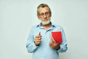 old man writes down emotions in a notebook light background photo