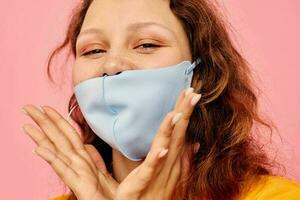 funny girl in a yellow t-shirt medical mask protection Lifestyle unaltered photo