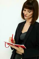 beautiful woman short haired red notepad and pencil isolated background photo