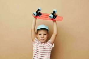 pretty young girl with a children's skateboard in hand smile isolated background photo