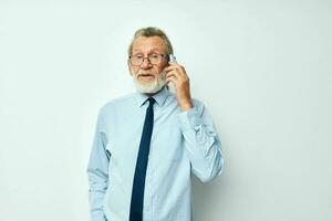 old man telephone communication glasses official light background photo