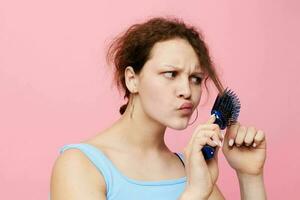 portrait of a woman in blue t-shirts comb with hair emotions isolated background unaltered photo