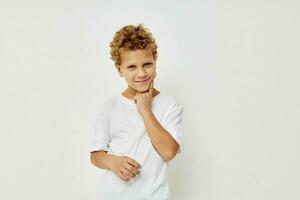 Cute little boy in a white t-shirt posing fun isolated background photo