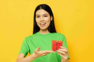 pretty brunette in green T-shirts with a small gift box Lifestyle unaltered photo