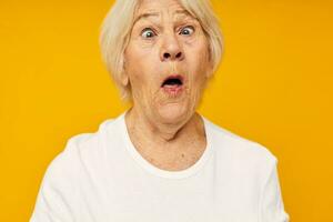 Portrait of an old friendly woman in white t-shirt posing fun close-up emotions photo