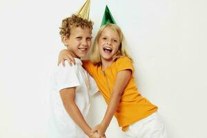 Cute preschool kids in multicolored caps birthday holiday emotion lifestyle unaltered photo