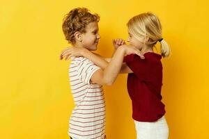 cheerful children casual wear games fun together on colored background photo