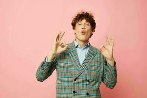 Young curly-haired man gesturing with his hands emotions checkered jacket Lifestyle unaltered photo