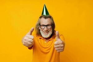 Portrait of happy senior man fun birthday cap on the head isolated background photo