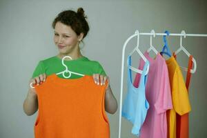 pretty girl green t-shirts near clothes hangers isolated backgrounds unaltered photo