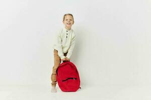 pretty young girl red backpack stylish clothes isolated background photo