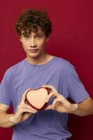 cute curly guy in purple t-shirt heart shaped box gift photo