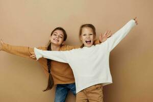 two girlfriends together kids fun studio beige background photo