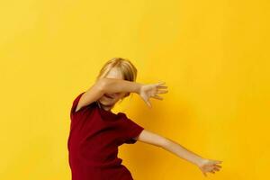 little girl sitting on the floor on a yellow background photo