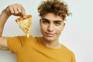 Attractive man eating pizza posing close-up isolated background photo