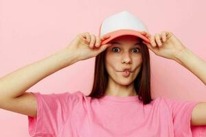 smiling woman pink t-shirts with cap on her head fashion summer style photo