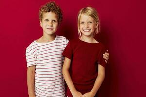 picture of positive boy and girl good mood standing next to posing isolated background photo