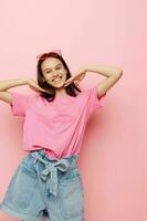 photography pretty woman in a pink t-shirt casual clothes pink background photo