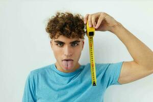 hermoso chico azul camiseta medición cinta posando estilo de vida inalterado foto