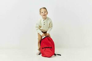 little girl red backpack stylish clothes isolated background photo