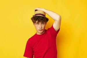 Young man with curly hair on yellow background photo