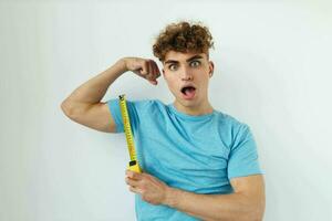 Attractive man yardstick in hand in blue t-shirts Lifestyle unaltered photo