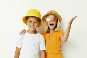 funny boy and girl wearing hats posing fashion light background photo