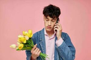 Photo of romantic young boyfriend in a denim jacket with a bouquet of flowers a gift romance Lifestyle unaltered