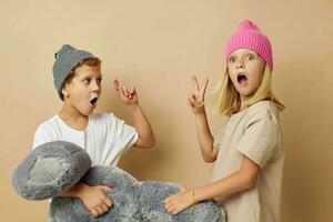 Portrait of cute children standing next to posing toy emotions isolated background photo