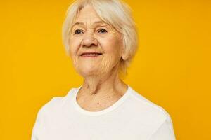 Photo of retired old lady in white t-shirt posing fun yellow background