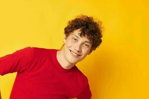 Young curly-haired man summer style fashion posing isolated background unaltered photo